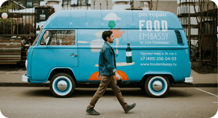 A man with WalkingPal app walking beside a van